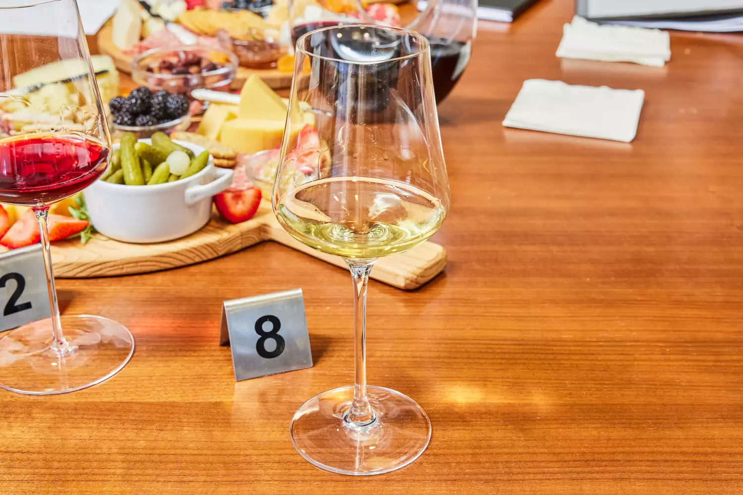Gabriel-Glas StandArt Crystal Wine Glasses Set glasses with red and white wines on a wood table with cheese boards
