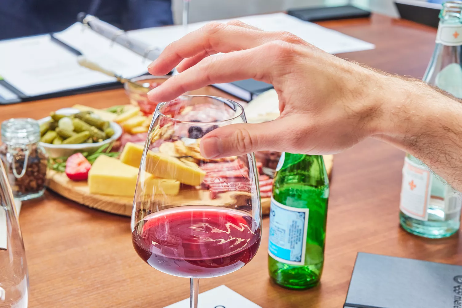 A person holding red wine filled on Made In Red Wine Glass