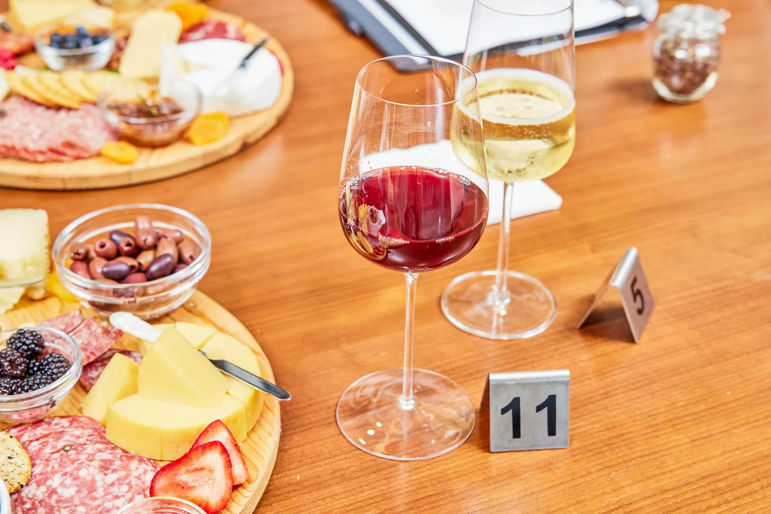 Glasvin Universal Wine Glasses, Set of 2, filled with different wines next to cheese and meat platters on wood table