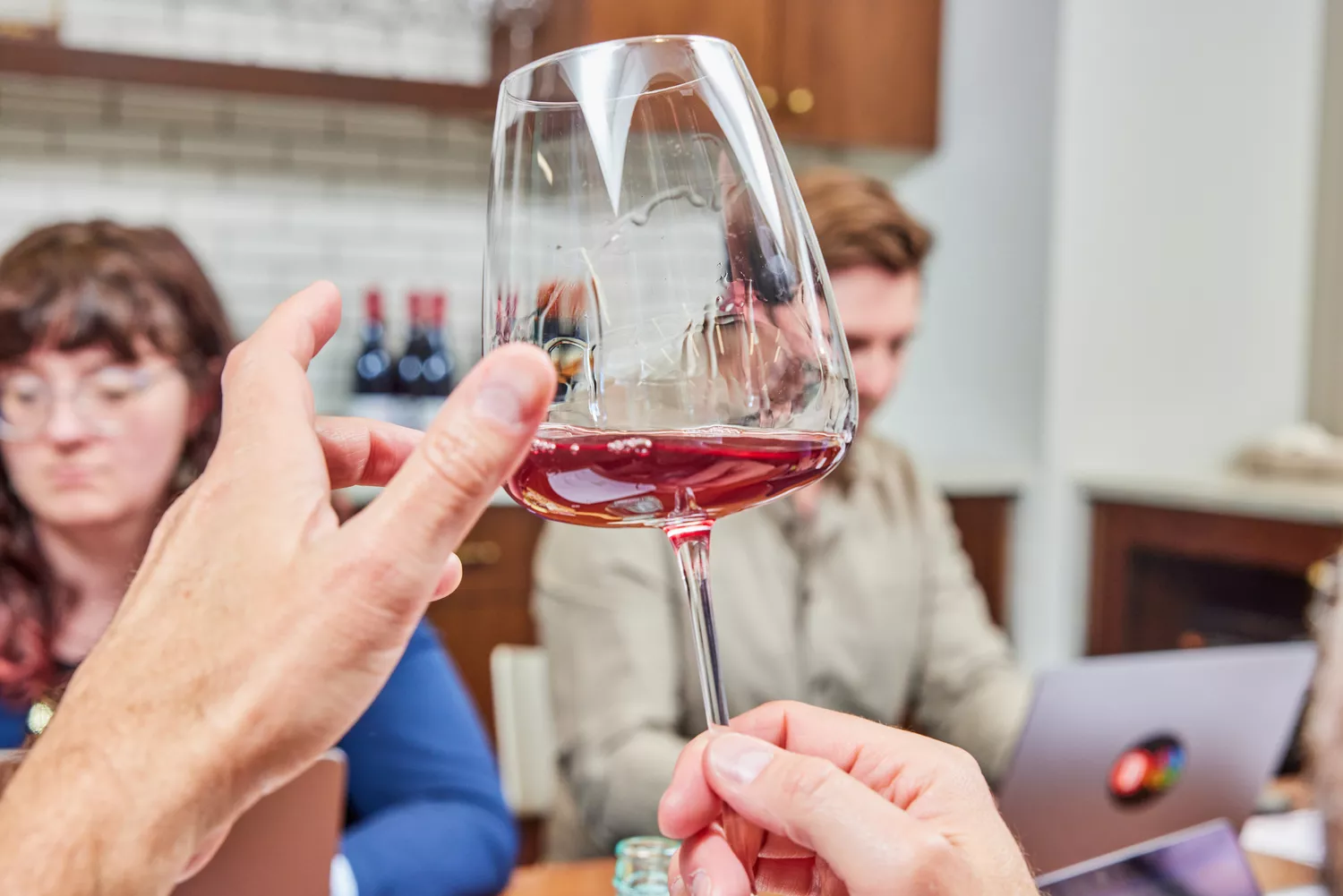 A person holding red wine filled on Made In Red Wine Glass