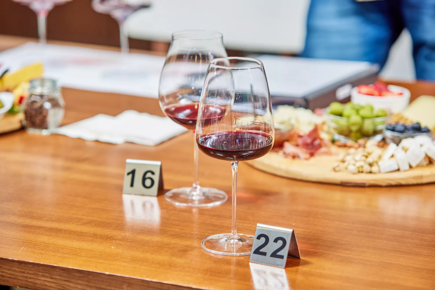Made In Red Wine Glasses placed on table with tokens for each glass filled with red wine